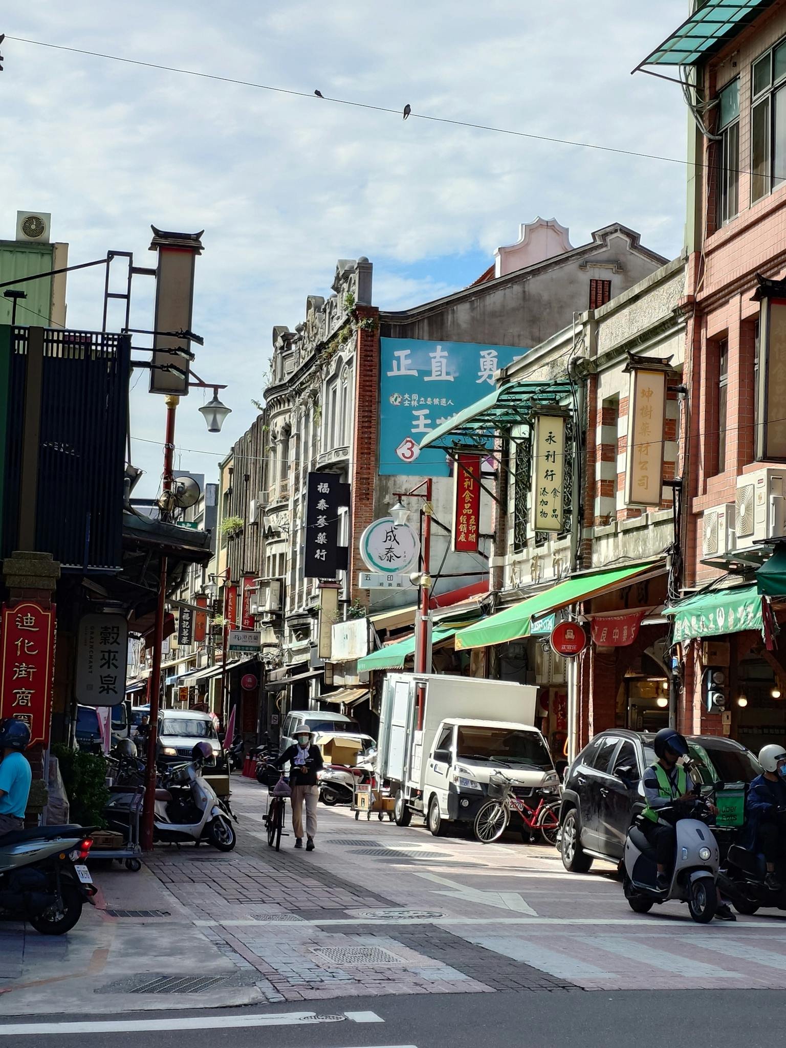 Vibrant urban street scene with shops, signs, and people in Asia, capturing the hustle and bustle.